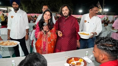 At Jogwad village near Reliance Township in Jamnagar, Mukesh Ambani, Anant Ambani and other members of the Ambani family, including Radhika Merchant, served traditional Gujarati food to the villagers.&nbsp; (AP)