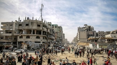 Palestinians gather in a street as humanitarian aid is airdropped in Gaza City on March 1, 2024, amid the ongoing conflict between Israel and the Hamas militant group. (AFP) Palestinians gather in a street as humanitarian aid is airdropped in Gaza City on March 1, 2024, amid the ongoing conflict between Israel and the Hamas militant group. (AFP)