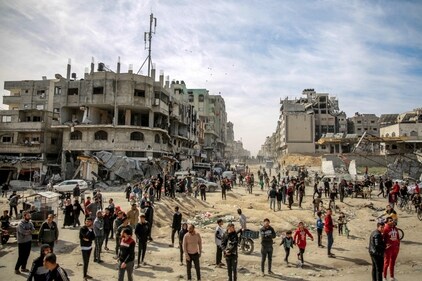 TOPSHOT - Palestinians gather in a street as humanitarian aid is airdropped in Gaza City on March 1, 2024, amid the ongoing conflict between Israel and the Hamas militant group. (AFP) TOPSHOT - Palestinians gather in a street as humanitarian aid is airdropped in Gaza City on March 1, 2024, amid the ongoing conflict between Israel and the Hamas militant group. (AFP)