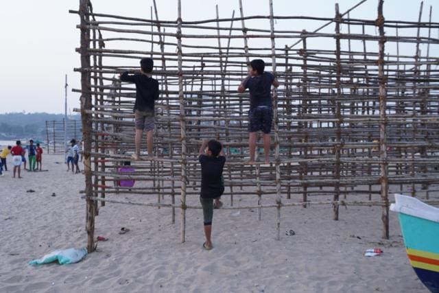 Children playing on wooden lattices used to dry fish (Suhit Bombaywala) Children playing on wooden lattices used to dry fish (Suhit Bombaywala)