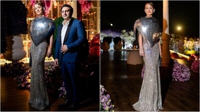 Natasha Poonawalla's sense of style never ceases to amaze us. For Anant Ambani and Radhika Merchant's pre-wedding festivities, the fashionista sported a silver metal dome by the brand Bloni, which is made entirely of aluminium. Her awe-inspiring top was paired with a silver maxi skirt from Maish Malhtra's collection, which was adorned with shimmering embellishments all over, adding to the glam factor. With a stunning make-up look, her hair was tied in a bun and adorned with a silver fancy clip to complete her glam look. (Instagram) Natasha Poonawalla's sense of style never ceases to amaze us. For Anant Ambani and Radhika Merchant's pre-wedding festivities, the fashionista sported a silver metal dome by the brand Bloni, which is made entirely of aluminium. Her awe-inspiring top was paired with a silver maxi skirt from Maish Malhtra's collection, which was adorned with shimmering embellishments all over, adding to the glam factor. With a stunning make-up look, her hair was tied in a bun and adorned with a silver fancy clip to complete her glam look. (Instagram)