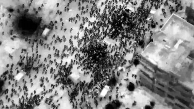 This image grab from a handout video released by the Israeli army on February 29, 2024, shows what the army says are Gazans around aid trucks in Gaza City. (AFP)