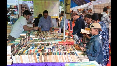 Young book lovers peruse titles on display on the first day of the nine-day Lucknow Book Fair, on the Ravindralay Lawns, in ucknow, on Saturday. (HT Photo)