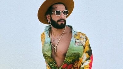 Ranveer Singh took the theme seriously in his look for the day. The actor paired a jungle-themed shirt with white trousers and a yellow hat. Ranveer Singh took the theme seriously in his look for the day. The actor paired a jungle-themed shirt with white trousers and a yellow hat.