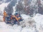 A snow clearing machine being used to remove snow from a road at Sissu, in Lahaul and Spiti district, Sunday. (PTI) A snow clearing machine being used to remove snow from a road at Sissu, in Lahaul and Spiti district, Sunday. (PTI)