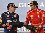 First placed Red Bull Racing's Dutch driver Max Verstappen (L) and third placed Ferrari's Spanish driver Carlos Sainz Jr celebrate during the podium ceremony First placed Red Bull Racing's Dutch driver Max Verstappen (L) and third placed Ferrari's Spanish driver Carlos Sainz Jr celebrate during the podium ceremony