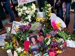 Flowers and a photograph of Aaron Bushnell are seen on a memorial as demonstrators rally during a pro-Palestinian demonstration outside of the Israeli Embassy in Washington, Saturday, March 2, 2024 (AP Photo/Jose Luis Magana)