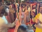MS Dhoni plays Dandiya with Sakshi and Dwayne Bravo. MS Dhoni plays Dandiya with Sakshi and Dwayne Bravo.