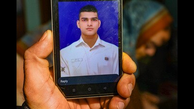 Family members show a photo of Navy sailor Sahil Verma who has been reported missing from a naval ship while on deployment, in Jammu on Sunday. (PTI) Family members show a photo of Navy sailor Sahil Verma who has been reported missing from a naval ship while on deployment, in Jammu on Sunday. (PTI)