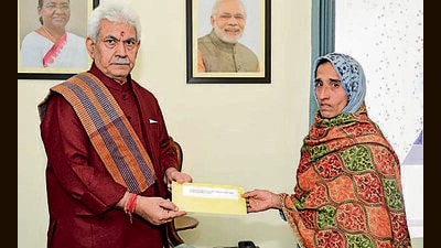 Lieutenant governor Manoj Sinha hands over an appointment letter to the wife of one of the victims in Jammu on Sunday. (HT Photo) Lieutenant governor Manoj Sinha hands over an appointment letter to the wife of one of the victims in Jammu on Sunday. (HT Photo)