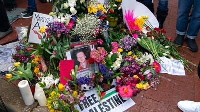 Flowers and a photograph of Aaron Bushnell are seen on a memorial as demonstrators rally during a pro-Palestinian demonstration outside of the Israeli Embassy in Washington, Saturday, March 2, 2024 (AP Photo/Jose Luis Magana) (AP)