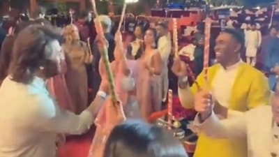 MS Dhoni plays Dandiya with Sakshi and Dwayne Bravo. MS Dhoni plays Dandiya with Sakshi and Dwayne Bravo.