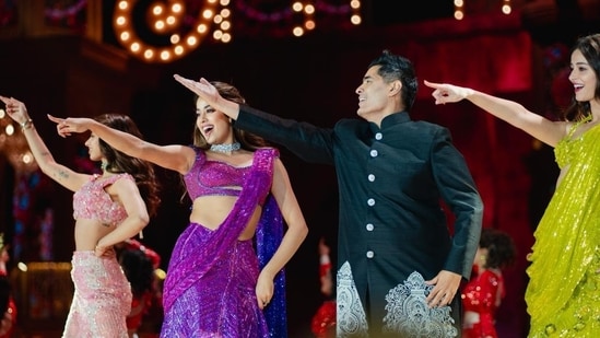 Khushi Kapoor, Janhvi Kapoor, and Ananya Panday dance with Manish Malhotra at the event. While Janhvi wore a purple lehenga, Ananya opted for a neon green dress and Khushi was seen in a pink outfit.