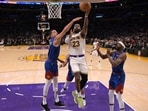 Los Angeles Lakers forward LeBron James (23) drives past Denver Nuggets forward Michael Porter Jr. (1) to score his 40,000th career point.