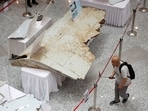 A visitor looks at the wreckage of an aircraft believed to be from the missing Malaysia Airlines flight MH370 during a remembrance event 