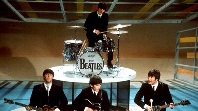 The Beatles, foreground from left, Paul McCartney, George Harrison, John Lennon and Ringo Starr on drums perform on the CBS "Ed Sullivan Show" in New York on  Feb. 9, 1964. (AP)