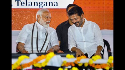 Prime Minister Narendra Modi with Telangana chief minister A Revanth Reddy during the launch of development initiatives, in Adilabad on Monday. (PTI)