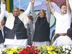 RJD chief Lalu Prasad Yadav, Congress President Mallikarjun Kharge and party leader Rahul Gandhi join hands during the RJD's 'Jan Vishwas Maha Rally', at Gandhi Maidan in Patna on Sunday.