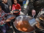TOPSHOT - Palestinian children receive cooked food rations as part of a volunteer youth initiative in Rafah in the southern Gaza Strip, on March 5, 2024, amid widespread hunger in the besieged Palestinian territory as the conflict between Israel and the Palestinian militant group Hamas continues. (Photo by MOHAMMED ABED / AFP) TOPSHOT - Palestinian children receive cooked food rations as part of a volunteer youth initiative in Rafah in the southern Gaza Strip, on March 5, 2024, amid widespread hunger in the besieged Palestinian territory as the conflict between Israel and the Palestinian militant group Hamas continues. (Photo by MOHAMMED ABED / AFP)
