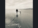 Daniella T. with her dog at a beach. Daniella T. with her dog at a beach.
