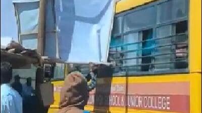 An illegal hoarding got stuck to the window of a moving school bus on NIBM Road on Tuesday morning posing danger to children onboard. (HT)
