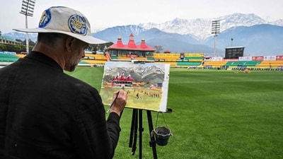 Andy Brown, a British artist, paints the cricket field during a practice session at the Himachal Pradesh Cricket Association Stadium in Dharamsala (AFP) Andy Brown, a British artist, paints the cricket field during a practice session at the Himachal Pradesh Cricket Association Stadium in Dharamsala (AFP)