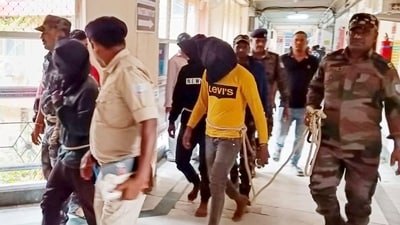 Police personnel escort men accused for allegedly carrying out a brutal assault on a Spanish woman, to a district court in Dumka, (AFP)