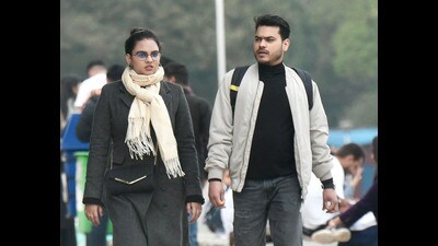 Visitors bundled up in woollens at Sukhna Lake in Chandigarh on Tuesday. (Keshav Singh/HT) Visitors bundled up in woollens at Sukhna Lake in Chandigarh on Tuesday. (Keshav Singh/HT)