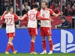Bayern Munich's English forward Harry Kane (R) celebrates scoring the opening goal with his teammates during the UEFA Champions League match vs Lazio