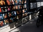 A person rides a bicycle past photos of hostages who were kidnapped in the deadly October 7 attack on Israel by the Palestinian Islamist group Hamas from Gaza, in Tel Aviv, Israel March 6, 2024. REUTERS/Carlos Garcia Rawlins(REUTERS)