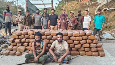 Security personnel with the seized cannabis consignment and the smugglers. (Sourced image,) Security personnel with the seized cannabis consignment and the smugglers. (Sourced image,)