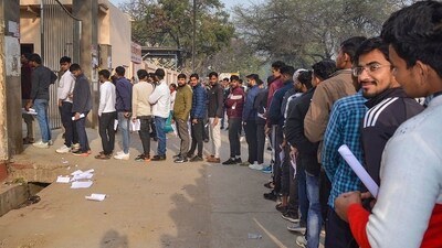 Candidates wait in a queue to appear in the UP Police Constables recruitment exam in Mathura (PTI) Candidates wait in a queue to appear in the UP Police Constables recruitment exam in Mathura (PTI)