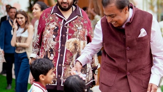Mukesh Ambani shares a light moment with his grandchildren at the pre-wedding celebrations of his son Anant Ambani and daughter Radhika Merchant in Jamnagar.(ANI)