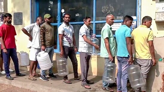 People stand in queues to get drinking water as areas like Whitefield, Mahadevpura and RR Nagar face drinking water shortages, in Bengaluru on Sunday. (ANI)