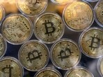 (FILES) Physical imitations of bitcoins are pictured at a cryptocurrency exchange branch near the Grand Bazaar in Istanbul on October 20, 2021.  (Photo by Ozan KOSE / AFP)