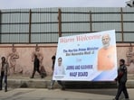 People carry a hoarding board outside the Bakshi stadium a day ahead of Indian Prime Minister Narendra Modi's visit, in Srinagar, India March 6, 2024.