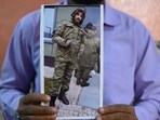 This photo taken on February 22, 2024, shows a picture printout of Indian national Mohammed Asfan, seen wearing Russian military fatigues who last called family from the southern Russian city of Rostov-on-Don before being deployed amid the conflict in Ukraine. This photo taken on February 22, 2024, shows a picture printout of Indian national Mohammed Asfan, seen wearing Russian military fatigues who last called family from the southern Russian city of Rostov-on-Don before being deployed amid the conflict in Ukraine.