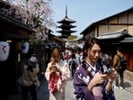 A crowd of tourists walk on the street near Kiyomizu-dera temple in Kyoto, western Japan March 30, 2023.  