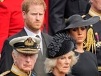 FILE - Britain's King Charles III, from bottom left, Camilla, the Queen Consort, Prince Harry and Meghan, Duchess of Sussex watch as the coffin of Queen Elizabeth II is placed into the hearse following the state funeral service in Westminster Abbey in central London Monday Sept. 19, 2022. Queen Camilla, once seen as the scourge of the House of Windsor, the woman at the heart of King Charles III’s doomed marriage to the late Princess Diana, has emerged as one of the monarchy’s most prominent emissaries. (AP Photo/Martin Meissner, Pool, File)