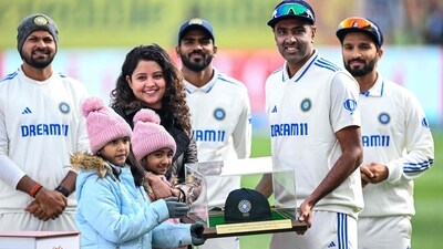 India's Ravichandran Ashwin (2R) with his wife and children poses with a memento on his 100th Test match in Dharamsala (AFP) India's Ravichandran Ashwin (2R) with his wife and children poses with a memento on his 100th Test match in Dharamsala (AFP)