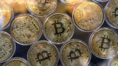 (FILES) Physical imitations of bitcoins are pictured at a cryptocurrency exchange branch near the Grand Bazaar in Istanbul on October 20, 2021. (Photo by Ozan KOSE / AFP) (AFP) (FILES) Physical imitations of bitcoins are pictured at a cryptocurrency exchange branch near the Grand Bazaar in Istanbul on October 20, 2021. (Photo by Ozan KOSE / AFP) (AFP)