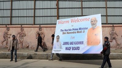 People carry a hoarding board outside the Bakshi stadium a day ahead of Indian Prime Minister Narendra Modi's visit, in Srinagar, India March 6, 2024. (Reuters)