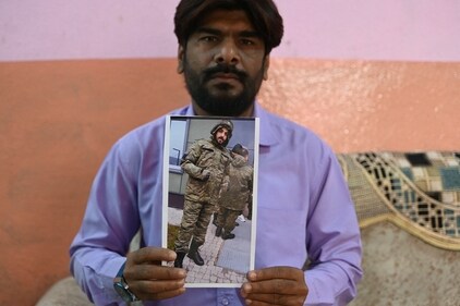 Mohammed Imran shows his brother Mohammed Asfan photo who is stranded in Russia along the war-torn Ukraine border, at their home in Hyderabad, on February 22, 2024. (AFP) Mohammed Imran shows his brother Mohammed Asfan photo who is stranded in Russia along the war-torn Ukraine border, at their home in Hyderabad, on February 22, 2024. (AFP)