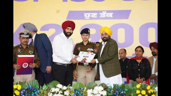 CM Bhagwant Mann hands over job letter to a youth at an event in Sangrur on Thursday. (HT photo)