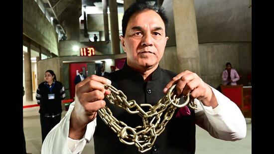 MLA Raj Kumar Chabbewal showing chains during a media interaction. (Ravi Kumar/HT)