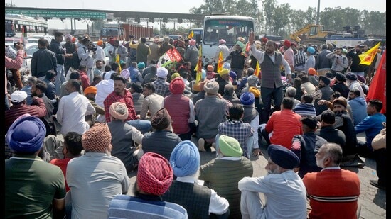 Members of the All-India Trucker Operators’ Union and other labour organisations holding a protest against the state government at Ladhowal toll plaza in Ludhiana on Thursday. (Gurpreet Singh/HT Photo)