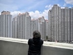 A man looks at apartment buildings in Jakarta on March, 7 2024. (Photo by BAY ISMOYO / AFP) A man looks at apartment buildings in Jakarta on March, 7 2024. (Photo by BAY ISMOYO / AFP)