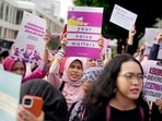 Activists display posters during an International Women's Day rally in Jakarta, Indonesia, Friday, March 8, 2024. (AP Photo/Dita Alangkara)