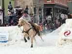 Skijoring draws its name from the Norwegian word skikjoring, meaning "ski driving." It started as a practical mode of transportation in Scandinavia and became popular in the Alps around 1900. Today's sport features horses at full gallop towing skiers by rope over jumps and around obstacles as they try to lance suspended hoops with a baton, typically a ski pole that's cut in half. Skijoring draws its name from the Norwegian word skikjoring, meaning "ski driving." It started as a practical mode of transportation in Scandinavia and became popular in the Alps around 1900. Today's sport features horses at full gallop towing skiers by rope over jumps and around obstacles as they try to lance suspended hoops with a baton, typically a ski pole that's cut in half.