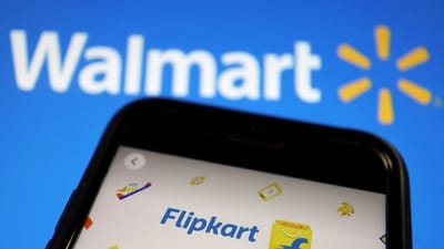 A mobile phone showing an image of Indian online retailer Flipkart is seen in front of a Walmart Inc logo displayed. (Reuters)
